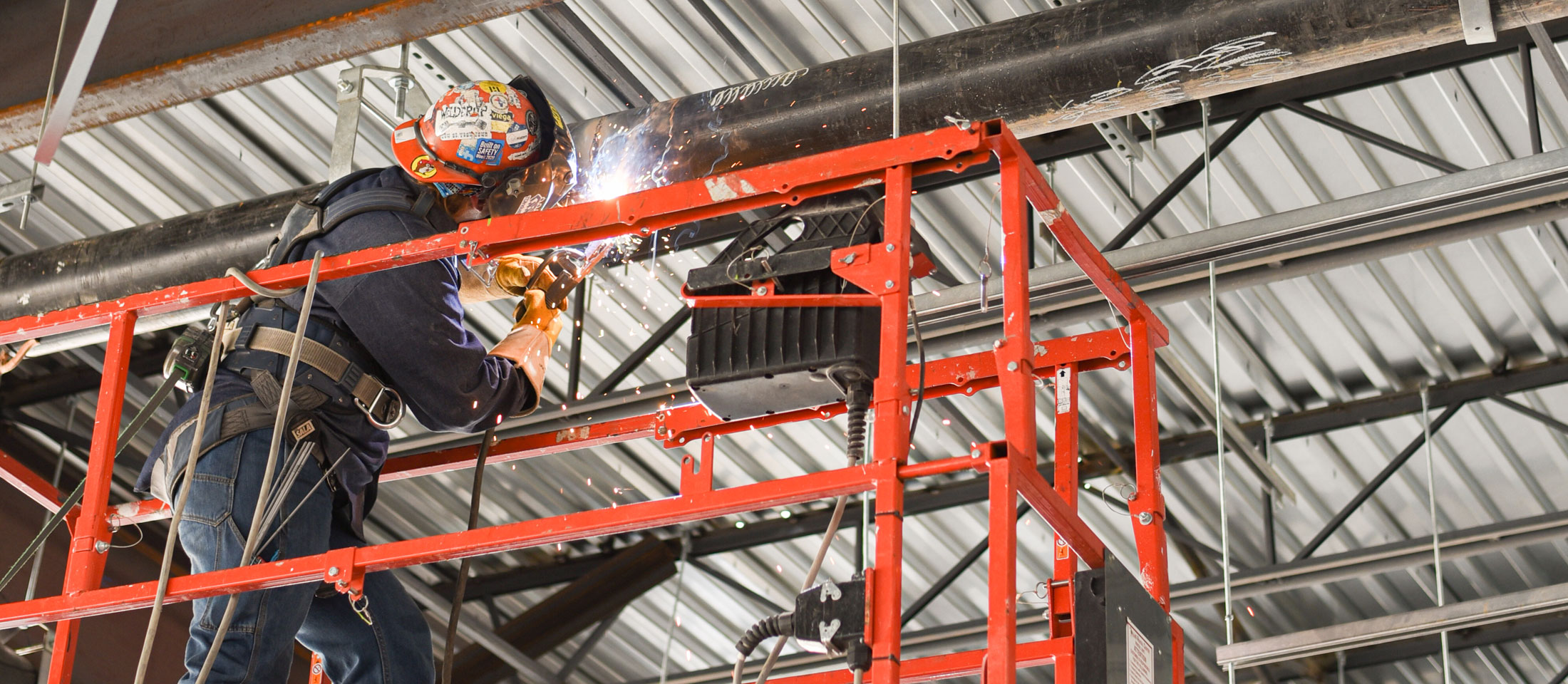 Kaylin Leas welding a pipe.